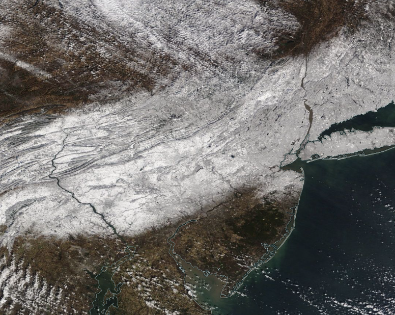 Figure 4. NASA MODIS visible satellite image on the morning of February 14th showing snow cover over New Jersey and surroundings north of approximately Interstate 195. The dark spot in west central NJ is unfrozen Round Valley Reservoir (Hunterdon). NJ skies are cloud-free except some scattered clouds in the far south. Clouds are located just to the northwest of Sussex County in Pennsylvania and New York. NASA