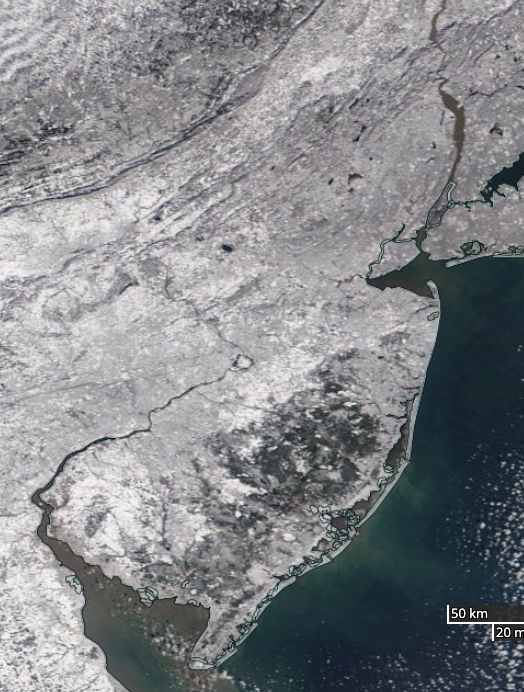 Figure 12. NASA MODIS visible satellite image on the morning of January 21st showing snow cover over all of New Jersey and surrounding states. The dark area in south Jersey is the Pinelands, where the coniferous trees “hide” the underlying snow cover from the satellite view. NASA MODIS visible satellite image on the morning of January 21st showing snow cover over all of New Jersey and surrounding states.