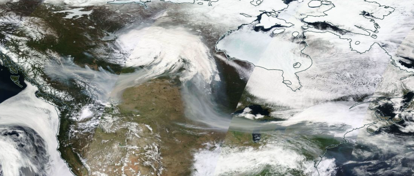 Figure 3. Visible satellite composite across North America on the morning of May 16th. Smoke (greyer than most clouds and snow-covered ground) can be seen emerging from wildfires in western Canada, being pulled into a low-pressure system to the east, and then flowing south and east by upper-level winds into the northern US Plains, across the Great Lakes and into the Northeast. (NASA MODIS imagery). Visible satellite composite across North America on the morning of May 16th. Smoke (greyer than most clouds and snow-covered ground) can be seen emerging from wildfires in western Canada, being pulled into a low-pressure system to the east, and then flowing south and east by upper-level winds into the northern US Plains, across the Great Lakes and into the Northeast.