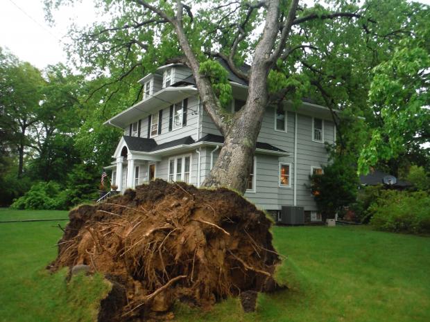 A large tree leans against a home in Ringwood (Passaic County) following severe thunderstorms on May 15. Photo by Boyd A. Loving/NorthJersey.com. Tree on house