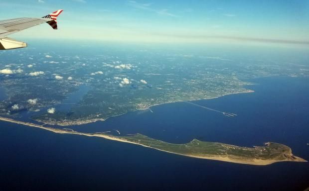 Sandy Hook and nearby Monmouth County and Raritan Bay on the morning of June 25th. A few low-altitude cumulus clouds (and their shadows) dot the landscape, while cirrus reside overhead. Photo by Doug Robinson. Sandy Hook from plane